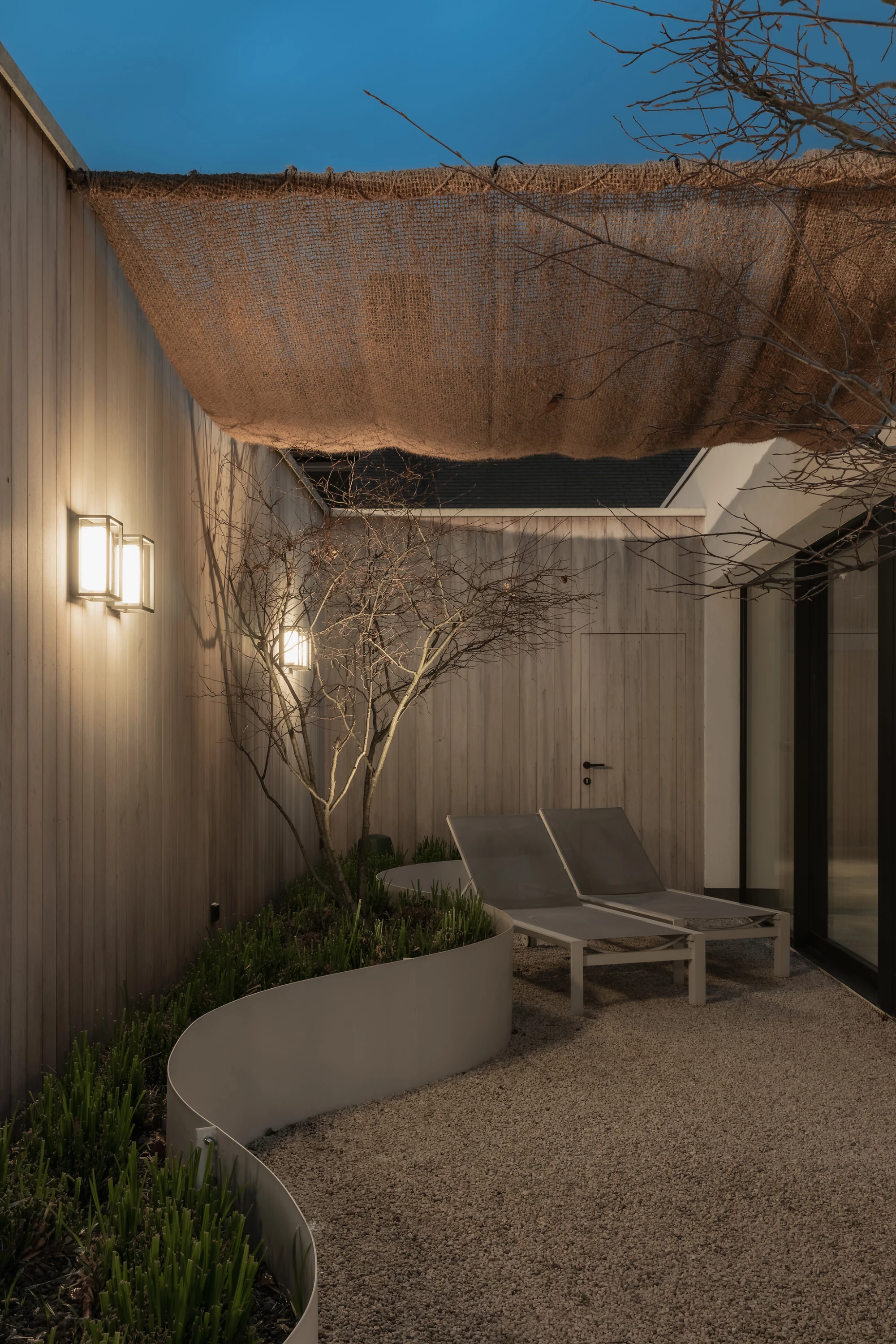 Terrace evening with loungers in private wellness Herenhuis Izegem